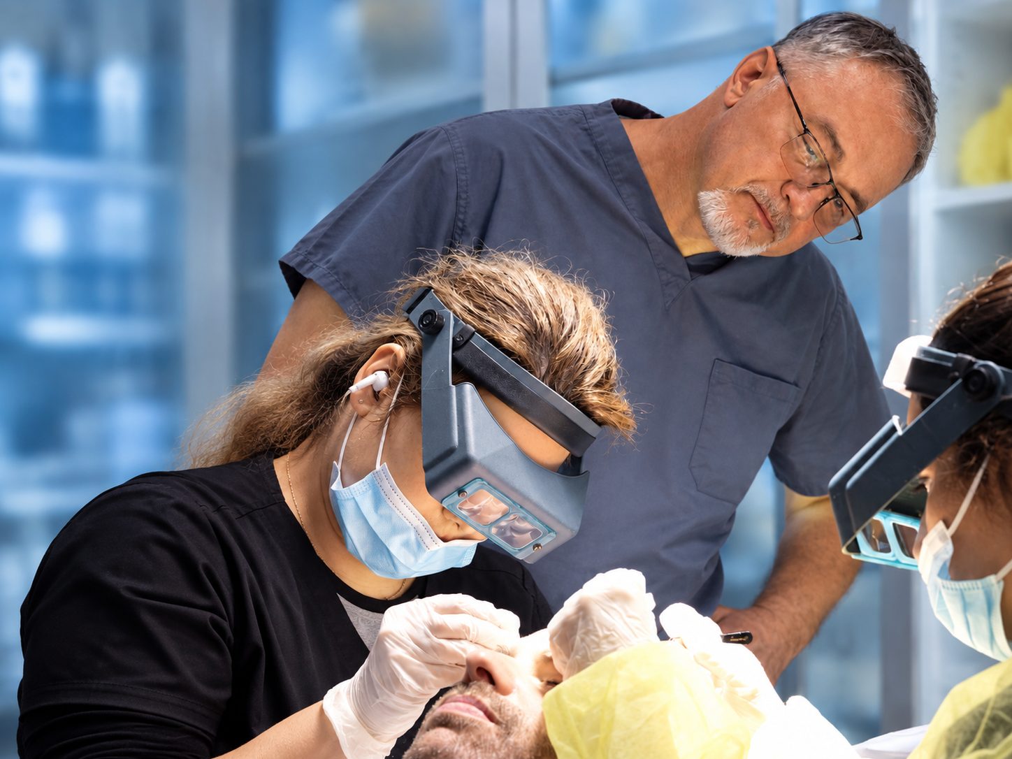 Dr. Val Prokurat, MD overseeing a technician wearing magnifying loupes during a transplant at Nova Medical NYC